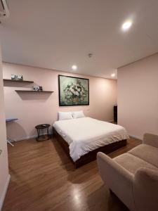a bedroom with a bed and a couch at 3415B Mipec Riverside nice view in Hanoi