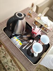 a tea kettle on a tray on a table at Nana Pyramids Guest House in Cairo