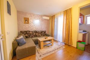 a living room with a couch and a table at Apartments and bungalow Casa Palma in Ulcinj