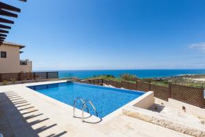 a swimming pool with a view of the ocean at Aphrodite Hills Rentals - Mythos in Kouklia