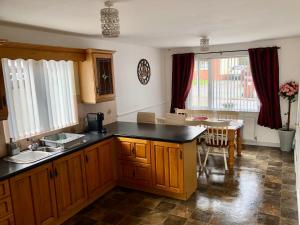 a kitchen with a counter and a table and chairs at Cleomack House - Perfect for two in Hilltown