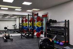 a gym with a bunch of equipment in a room at Casa Tamarama in Sydney
