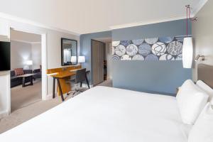 a hotel room with a bed and a desk at Crowne Plaza Harrogate by IHG in Harrogate +103 photos