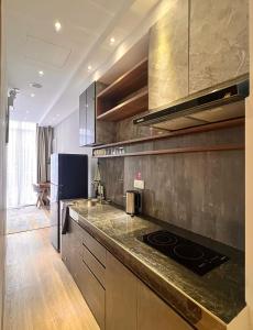 a kitchen with a stove and a counter top at oxy suites 1-01B at Shop House Meisterstadt Pollux Habibie in Batam Center