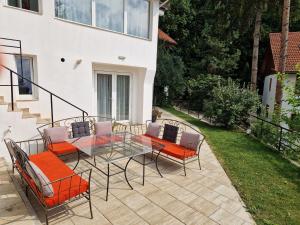 a patio with a glass table and chairs at Spirii house in Braşov