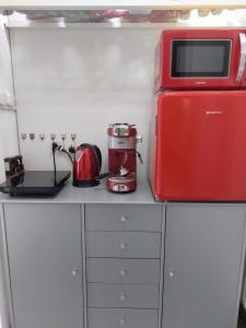 a kitchen with a red appliance on a counter at Casa Negoiu in Târgu-Mureş