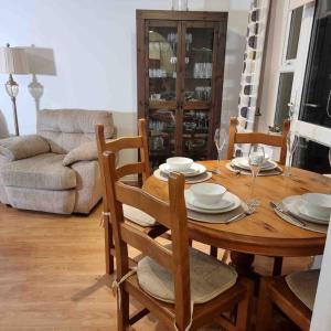 a wooden table with chairs and a dining room at cosy one bed Mill hill in Hendon
