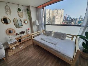 a bedroom with a bed and a large window at Fall in the view in Seoul