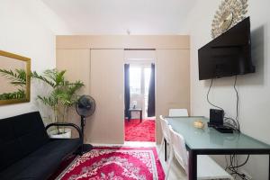 a living room with a couch and a table at Affordable condotel near Manila Airport in Manila