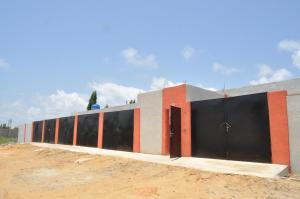 a building with black and orange doors on it at Motel Ayélawadjè Palm Beach in Ekpé