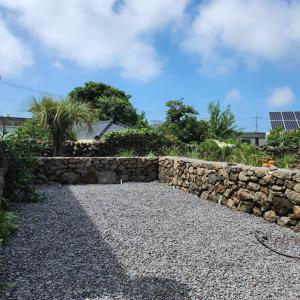 a stone wall next to a stone wall at Peace of mind in Jeju
