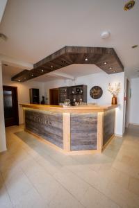 a bar in a room with a reception counter at Hotel National in Bad Düben