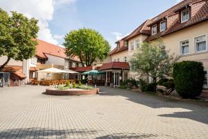 a cobblestone street in a town with buildings at Hotel National in Bad Düben