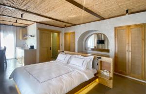 a bedroom with a large bed and a kitchen at Kas Marin Hotel in Kaş