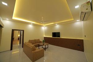 a living room with a couch and a table at Lake Valley Resort and Spa Tirupati in Tirupati