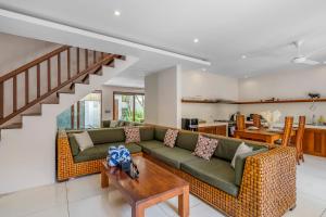 a living room with a couch and a table at Du Ciel Villa by Hombali in Canggu