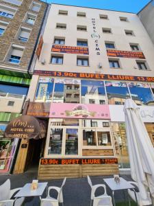 a building with tables and chairs in front of it at Hotel Cims Pas de La Casa in Pas de la Casa