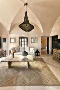a living room with a couch and a table at OIA UNIQUE HOMES by K&K in Oia +213 photos