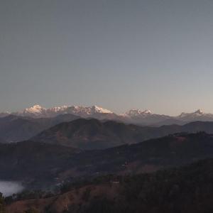 a view of a mountain range with snow capped mountains at Himalaya Mount View Resort Kausani in Kausani