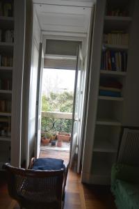 ナポリにある2 camere con pianoforteの本のある部屋に開くドア付きの廊下