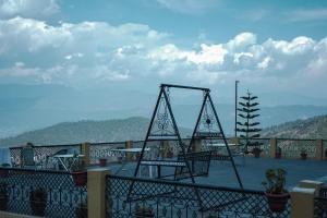 a metal object sitting on top of a balcony at Himalaya Mount View Resort Kausani in Kausani
