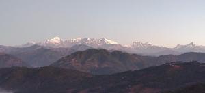 a view of a mountain range with snow capped mountains at Himalaya Mount View Resort Kausani in Kausani
