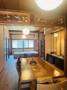 a living room with a table and a couch at えん飛鳥　日本始まりの地　古民家一棟貸し　8人＋大型犬も宿泊可能 in Asuka