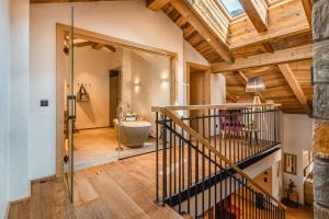 a room with a staircase and a bathroom with a sink at Apartmenthaus Wiesenhof in Aschau +72 photos