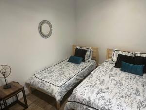 a bedroom with two beds and a mirror on the wall at Le Victor  in Saint-Raphaël