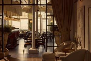 a restaurant with chairs and tables and windows at No 42 by GuestHouse, Margate in Margate