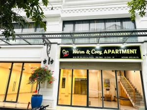 a store front with a sign for a woman and cozy apartment at Warm & Cozy Apartment in Hai Phong
