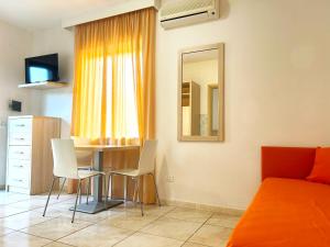 a bedroom with a bed and a table and chairs at Hotel Park Village in Rossano