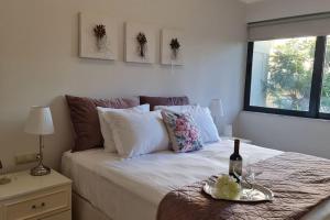 a bedroom with a bed with a bottle of wine on it at Luxury apartment in the heart of the city in Chania Town