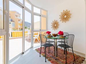 een eetkamer met een tafel en stoelen en een balkon bij 9 Parque Tropical Apartamento Los Cristianos in Los Cristianos