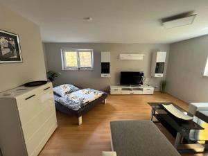 a living room with a bed and a table in it at Großzügige Ferienwohnung im Oberland in Warngau