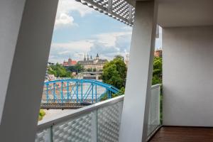 a balcony with a view of a bridge and buildings at Apartamenty City Tower od WroclawApartament-pl in Wrocław