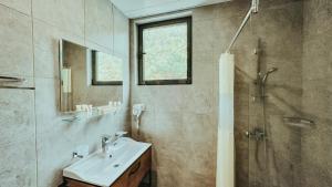 a bathroom with a sink and a shower at Парк СПА Отель Нарт in Gagra