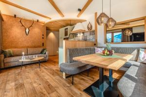 a living room with a couch and a table at Apartmenthaus Wiesenhof in Aschau