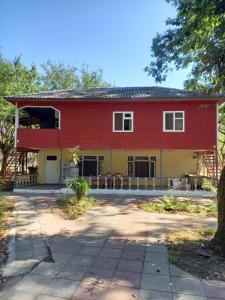 a red and yellow house with a patio at Тур центр Вилящ in Masallı