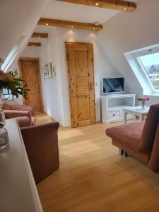 a living room with a couch and a tv at Villa am Meer in Westerland (Sylt)