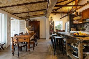 a large kitchen with a wooden table and chairs at The Cottage in the Valley - 3 bedroomed in Riebeek-Kasteel