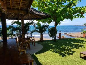 a restaurant on the beach with a view of the ocean at Marianita's cottages in Mambajao