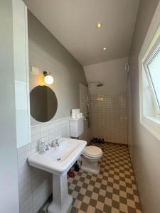 a bathroom with a sink and a toilet at Apartment in historical house in Oslo