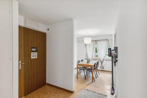 a room with a table and chairs and a door at PUNTSTRASSE 