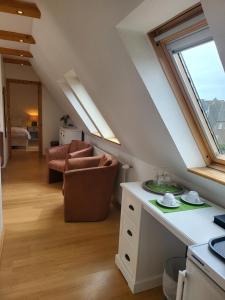 a kitchen and living room in a attic at Villa am Meer in Westerland