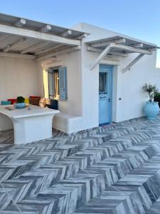 a living room with a tile floor and a table at My Naxian Home 1 in Agios Prokopios