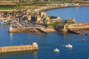 a view of a body of water with boats in it at MAISON GRAND LUXE PROX. STVAAST LA HOUGUE-BARFLEUR in Saint-Pierre-Église +9 photos