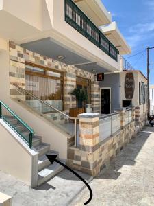a building with stairs in front of a restaurant at modern rustic house in the heart Of the village in Kefalos