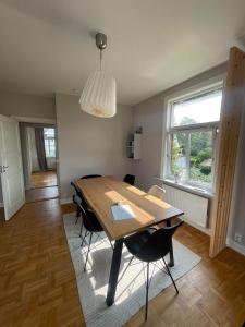 a dining room with a wooden table and chairs at Apartment in historical house in Oslo