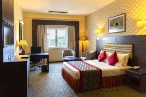 a hotel room with a bed and a desk at Ramada Katunayake in Katunayaka